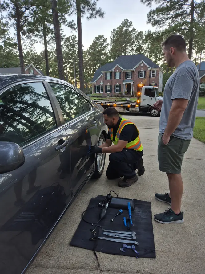 Technician unlocking a car door with lockout tools in Humble TX